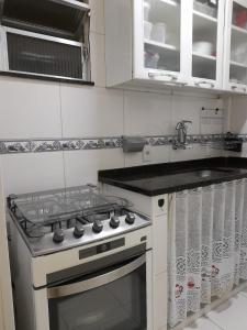 a kitchen with a stove and a sink at Apto lapa in Rio de Janeiro