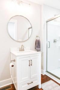 a white bathroom with a sink and a mirror at Sunny Hill Cottage with 4 Beds in Lincolnton