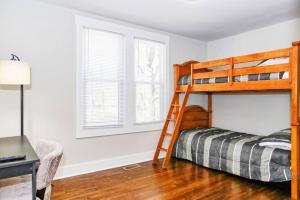 a bedroom with a bunk bed and a desk at Sunny Hill Cottage with 4 Beds in Lincolnton