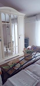 a white cabinet with a table in a room at DIMORA MAJELLA in Chieti