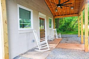 a porch with two rocking chairs and a ceiling fan at Newly Renovated Small Town Retreat in Maiden