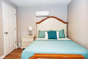 a bedroom with a large bed with blue pillows at Newly Renovated Small Town Retreat in Maiden