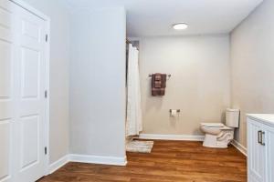 a bathroom with a toilet and a shower at Farm Lodge with Beautiful Open Floor Plan in Lincolnton +6 photos