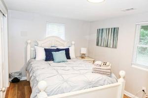 Dormitorio blanco con cama blanca y almohadas azules en Cozy Country Home with Room for Entire Family, 