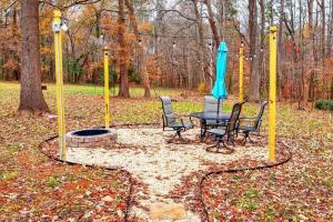 a patio with a table and chairs and an umbrella at Newly Renovated Salem Road Ranch in Lincolnton