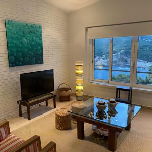 a living room with a tv and a coffee table at Cap Sa Sal 160 Begur in Begur