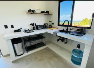 a kitchen with a sink and two windows at La Ventana Apartments View Island #4 in La Ventana +11 photos