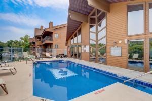 a swimming pool in front of a building at Stephs Waterfront Retreat Sunset Cove 303 in Wisconsin Dells