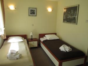 2 Betten in einem Hotelzimmer mit Handtüchern in der Unterkunft U Szelca in Krosno