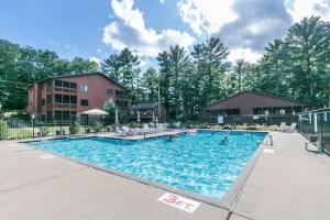 a swimming pool at a resort with people in it at Piers and Pines at Island Pointe in Wisconsin Dells