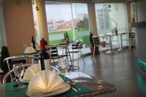 a table with a bottle of wine and glasses on it at HOTEL MURCIA AREQUIPA in Arequipa +36 photos