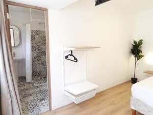 a bathroom with a shower and a mirror at Hotel Singular Antara in Mexico City