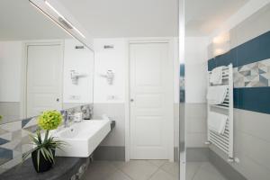 a white bathroom with a sink and a shower at Amalfi Casa Angelina in Amalfi