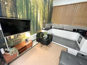 a living room with a large flat screen tv at Fabulous City Centre Apartments - Special Occassion Packages Available in Liverpool