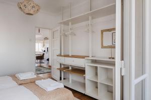 ein weißes Schlafzimmer mit einem Waschtisch und einem Spiegel in der Unterkunft Master Deco Gem in Graça in Lissabon