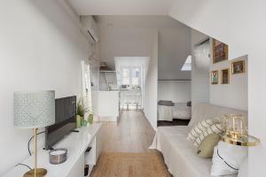 a white room with a bed and a living room at Romantic Gem with 2 Terraces in Alcântara in Lisbon