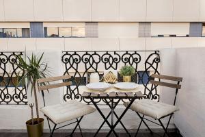 a table and two chairs on a balcony at Romantic Gem with 2 Terraces in Alcântara in Lisbon