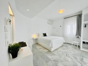 A bed or beds in a room at Paradiso Boutique