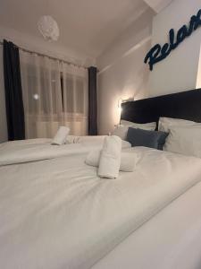 a white bed with two white pillows on it at Angel apartament in Sibiu