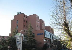 a large brown building with a sign in front of it at DIMORA MAJELLA in Chieti