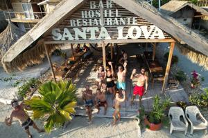 a group of people standing in front of a restaurant at Santa Lova Eco-hostel Isla Tintipan in Tintipan Island