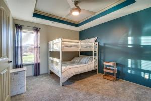 a bedroom with a bunk bed in a room at Luxe Missouri Getaway with Hot Tub and Fire Pit! in Oak Grove