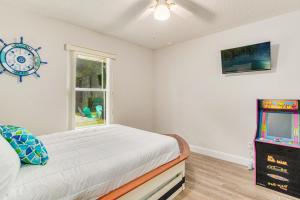 a bedroom with a bed and a clock on the wall at Goin' Coastal in Pensacola