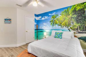 a bedroom with a bed with a palm tree mural at Goin' Coastal in Pensacola