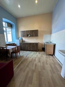 a room with a kitchen with a table and a dining room at HOSTEL124 in Baku