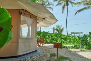 a small building with a sign in front of it at Playa Los Angeles in Los Naranjos