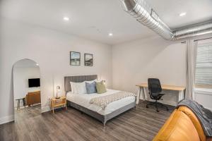 a bedroom with a bed and a desk in it at The Urban Oasis -brand New Corporate Apt Downtown in Grand Rapids