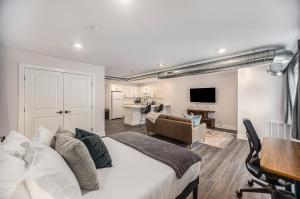 a bedroom with a large bed and a living room at Cityscape Suite -brand New Corporate Apt Downtown in Grand Rapids