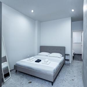 a bedroom with a bed in a white room at Luxury Downtown Apartment Α3 in Thessaloniki