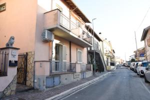 a building with balconies and cars parked on a street at Loft moderno amore mio in Formello