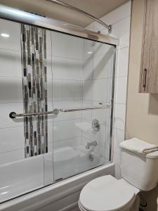 a bathroom with a shower and a toilet at Western Budget Motel #1 Leduc/Nisku in Leduc