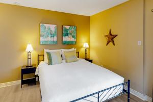 a bedroom with a large white bed with yellow walls at Condo 816 at North Creek Resort in Blue Mountains +27 photos