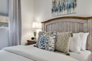a bedroom with a bed with pillows and a lamp at Water Well Wonder in Austin