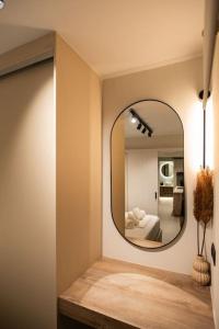 a mirror on a wall in a room with a bed at YOLO Resort- Giardino in Alykes