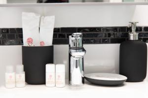 a bathroom counter with a blow dryer and other products at Loft moderno amore mio in Formello