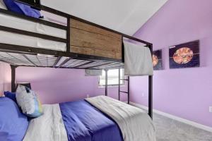 a bedroom with a bunk bed with purple walls at Overlook Landing in Buffalo Gap