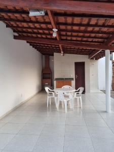 une salle à manger avec une table et des chaises blanches dans l'établissement Pousada Talismã, à Barreirinhas
