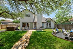 a house with a yard with chairs and a patio at Crested Oak in Cedar Park