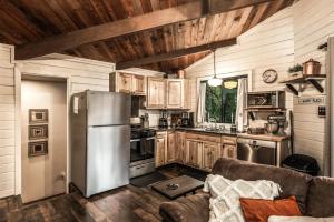 a kitchen with a stainless steel refrigerator and wooden cabinets at Peak In The Pines in Ruidoso