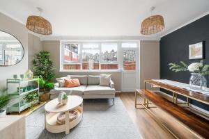 a living room with a couch and a table at Stylish 3 Bed with Outdoor space in Vibrant East London in London