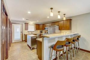 a kitchen with wooden cabinets and bar stools at WFC IV Adults or Families Lakefront View in Wisconsin Dells