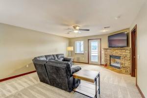 a living room with a leather couch and a fireplace at WFC IV Adults or Families Lakefront View in Wisconsin Dells