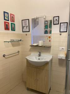 a bathroom with a sink and a mirror at Navona "The Corner" in Rome