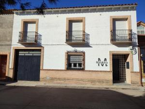 a white building with balconies on the side of it at Matallana 32 in Herencia