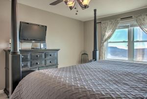 a bedroom with a bed and a tv and a window at Carolina North by VCI Real Estate Services in Beech Mountain
