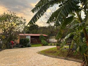 a brick driveway in front of a house at Caparica wood house in Caparica